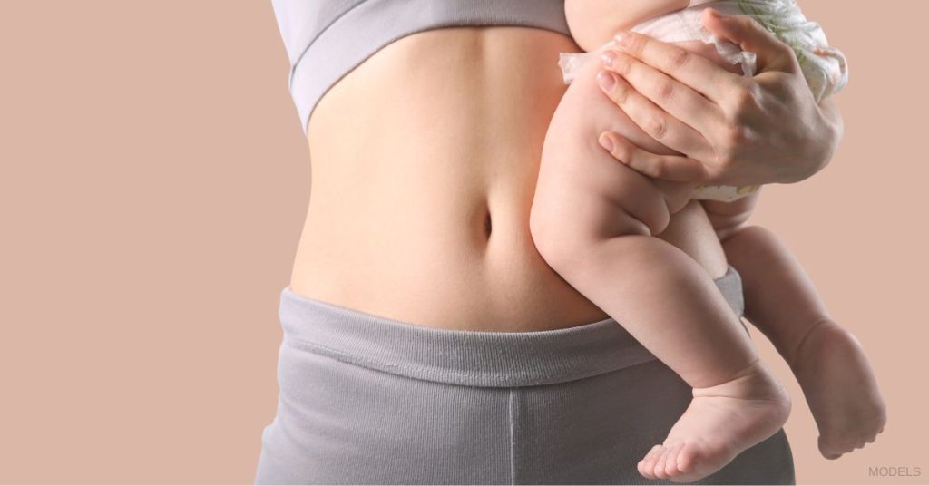 Woman in grey undergarments holding a baby. (MODELS)