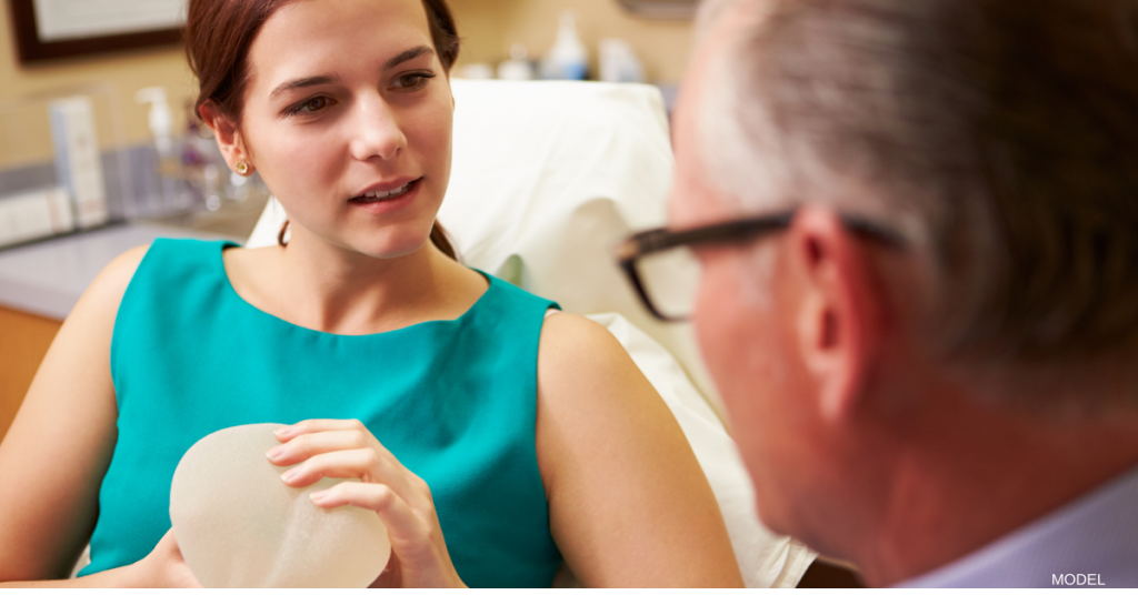 woman talking to doctor at her breast augmentation consultation