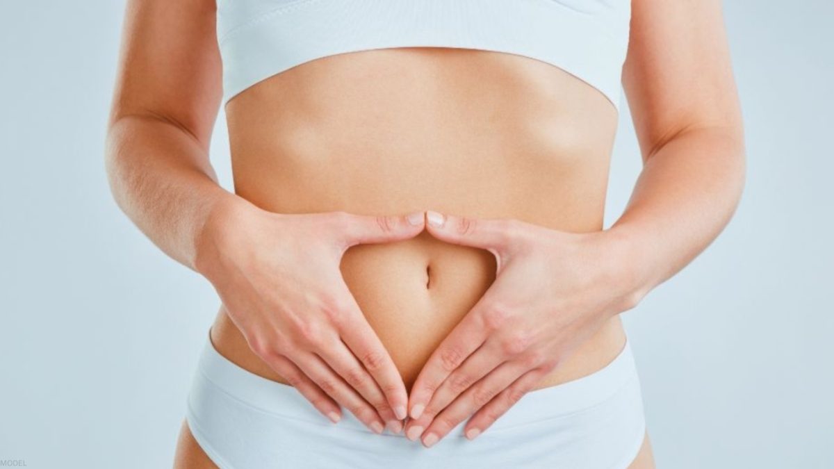 Woman with her hands on her stomach (model)
